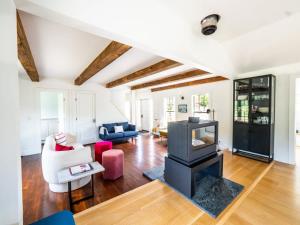 a living room with a fireplace and a couch at Berkshire Vacation Rentals: Stunning 1860 Farmhouse Private Pond & Hot Tub in Taghkanic