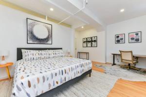 a bedroom with a bed and a desk and a piano at South End Hospitality: Downtown Crossing Large Lofted Condo Location in Boston