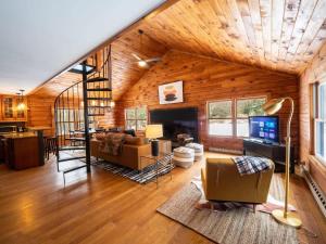 a living room with a couch and a fireplace at Berkshire Vacation Rentals: Private Cabin On Over 12 Acres Of Woods in Becket