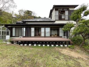 a house with a large porch in front of it at 【 円 madoka 】逗子鎌倉で暮らすように過ごす一棟貸し宿泊施設​ in Zushi