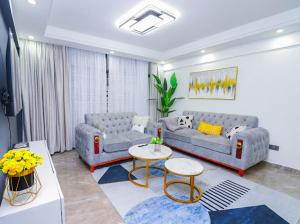 a living room with two couches and a table at Fabby homes in Nairobi