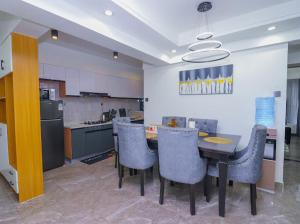 a kitchen with a table and chairs in a kitchen at Fabby homes in Nairobi