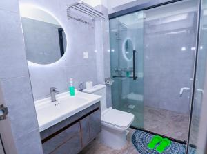 a bathroom with a shower and a toilet and a sink at Fabby homes in Nairobi