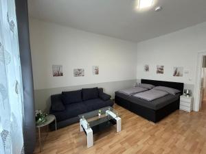 a living room with a bed and a couch at Paky Appartements 00210 in Vienna