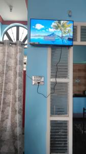 un mur avec une télévision au-dessus d'une porte dans l'établissement Dreamy bungalow 2BHK apartment, à Mysore