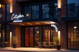 a restaurant with tables and chairs outside of a building at Cityden Stadshart in Amstelveen