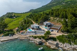 an aerial view of a house on a hill next to the water at Villa Luce Pelješac in Potomje