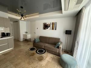 a living room with a couch and a table at Astria by the Sea Apartment in Olimp
