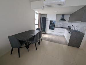 a kitchen and dining room with a table and chairs at Sea view Penthouse ABELIA 12 floors iskele Cyprus in Iskele