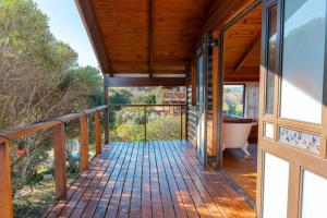 a deck with a bath tub and a bath tub at Flock-Inn in Fisherhaven
