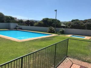 a swimming pool in a yard with a fence at Flock-Inn in Fisherhaven