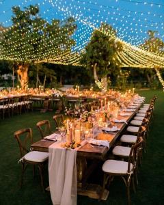 a long table with tables and chairs with lights at Villa Mandhari - Diani Beach in Diani Beach