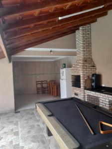 ein Wohnzimmer mit einem gemauerten Kamin und einem Tisch in der Unterkunft Imperial Fest in Guarulhos