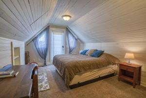 a bedroom with a bed and a wooden ceiling at The Ice Palace in Leadville