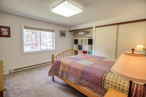 a bedroom with a bed and a window at Mountain Bluebell Cabin in Leadville
