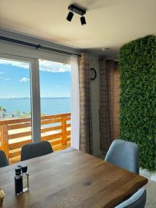 ein Esszimmer mit einem Tisch und Meerblick in der Unterkunft d-view Premium Mobile Home - panoramic seaview - 150 m from beach, free parking in Drage