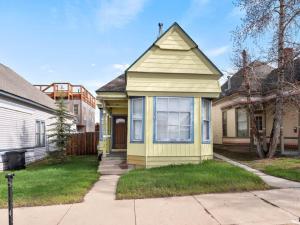 a yellow house with a window on a street at The Zinnia Victorian Charm with Mountain Views in Leadville