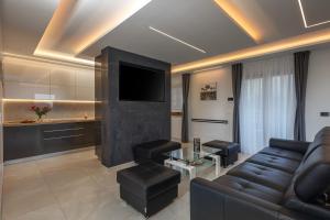 a living room with a couch and a tv at Villa Vilani Spa & Pool - Happy Rentals in Crikvenica