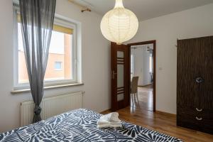 a bedroom with a bed and a window and a lamp at 32 Gdynia Oksywie - Apartament Mieszkanie dla 4 os in Gdynia