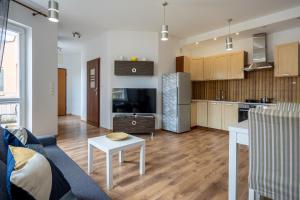 a living room with a couch and a table and a kitchen at 32 Gdynia Oksywie - Apartament Mieszkanie dla 4 os in Gdynia