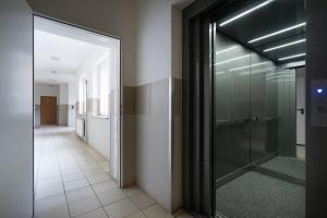 a hallway with a glass shower in a building at 32 Gdynia Oksywie - Apartament Mieszkanie dla 4 os in Gdynia
