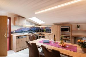 a kitchen with a table with a pineapple on it at Appartements Herold in Söll