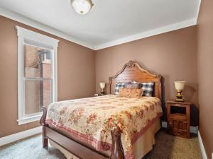 a bedroom with a large bed and a window at The Lady Sage in Leadville