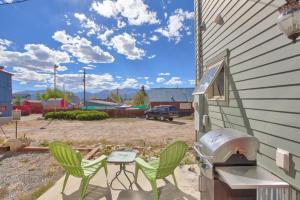 a backyard with a grill and chairs and a table at The Lady Sage in Leadville