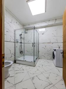 a bathroom with a glass shower and a toilet at Palas Suite 12 in Istanbul