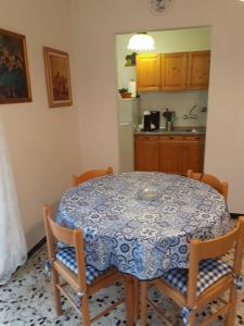 a kitchen with a table with a blue and white table cloth at Profumo di montagna San Giacomo di roburent in San Giacomo