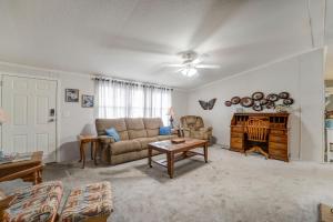 a living room with a couch and a table at 3 bed 2 bath with office room-with futon bed on Weiss Lake - with community ramp & dock in Centre