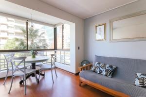 a living room with a couch and a table at Silver City with Parking & Wifi in Santiago