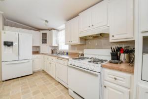 a white kitchen with white appliances and white cabinets at 3 bed 2 bath with office room-with futon bed on Weiss Lake - with community ramp & dock in Centre