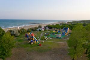 a park with a bunch of playground equipment on the beach at Villaggio San Paolo in Cavallino-Treporti