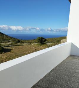 a white wall with a view of the ocean at Sophie's Pourko House in Kythira