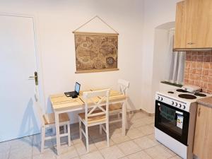 a small kitchen with a table and a stove at Sophie's Pourko House in Kythira