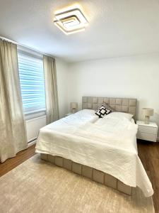 a bedroom with a large bed and a window at Apartment Alana in Hannover