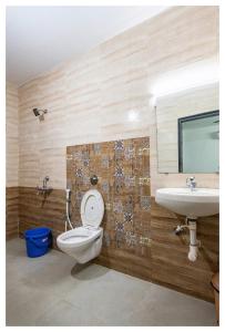 a bathroom with a toilet and a sink at Palash Villa in Aguada