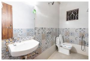 a bathroom with a sink and a toilet at Palash Villa in Aguada
