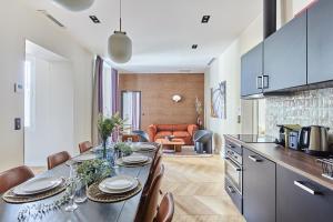 a kitchen and dining room with a table and chairs at Apartement Place Vendome by Studioprestige in Paris