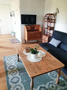 a living room with a coffee table and a couch at Gits Gard in Falkenberg