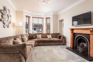 a living room with a couch and a fireplace at 67 Midton Road in Prestwick
