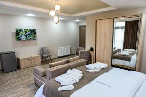a hotel room with a bed and a couch at Hotel K124 in Kutaisi