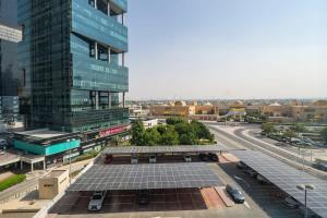 a view of a city with a building and a street at Frank Porter - V3 Tower in Dubai