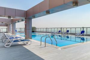 a swimming pool on the top of a building at Frank Porter - V3 Tower in Dubai