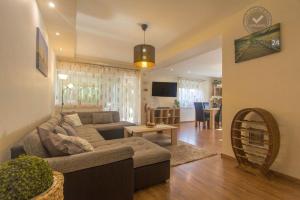 a living room with a couch and a table at Villa Eszter in Balatonkeresztúr