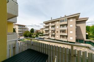a balcony with a white railing and a building at Luxemburg in Caorle