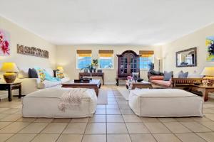 a large living room with two beds and a couch at NEW Amazing large 3BR direct oceanfront Penthouse On Ocean Drive!! in Miami Beach