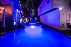 a pool with blue lights in a backyard at night at Amazing Modern Property 5 BR Next to French QT & Bourbon in New Orleans