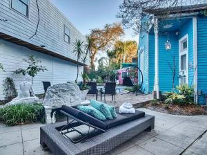 a patio with a couch and a table in front of a house at Amazing Modern Property 5 BR Next to French QT & Bourbon in New Orleans